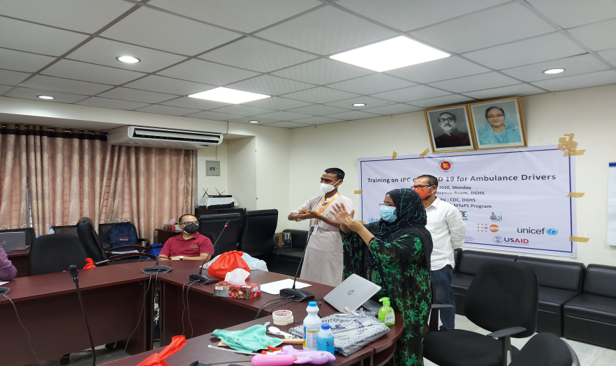 Training facilitators demonstrate handwashing during an IPC training for ambulance drivers in Dhaka, Bangladesh.