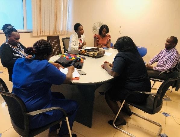 Mentoring participants in discussion around a table 