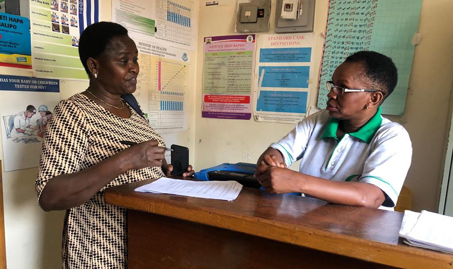 Two women having a discussion in a hospital office