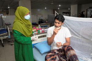 A patient receiving medication from a health provider at a hospital in Bangladesh