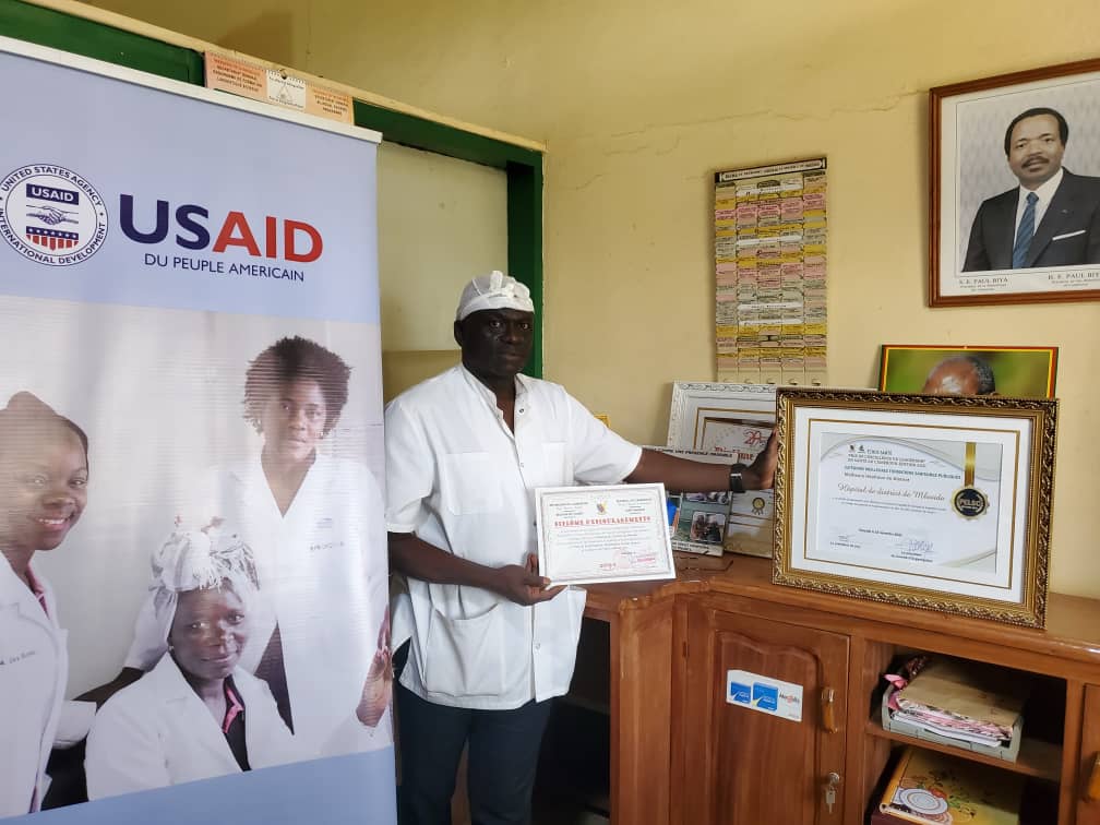 Mr. Gnitedem exhibiting the certificate of the second cleanest health facility in the West region. Photo credit: Mr. Acho, MTaPS