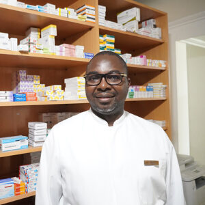 A pharmacist in front of medicines