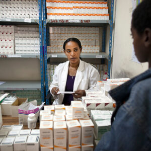 Two people discussing with medicines around them